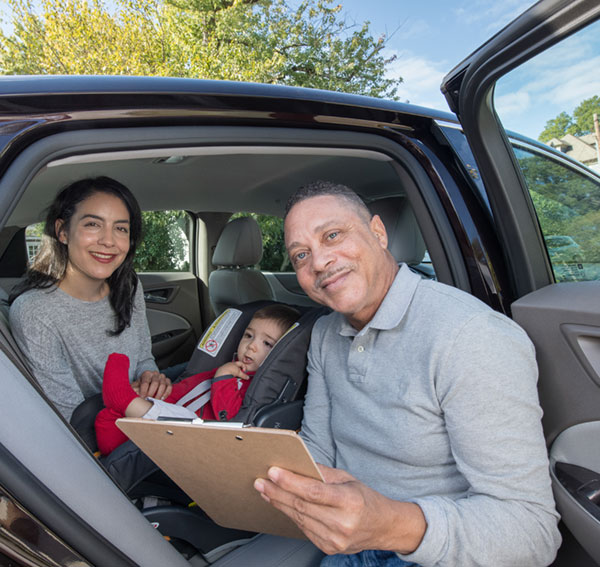 CPS Technician with mother and child checking a carseat