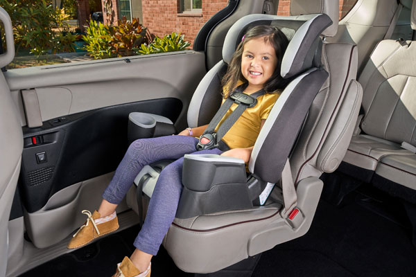 A child harnessed in a forward-facing car seat.